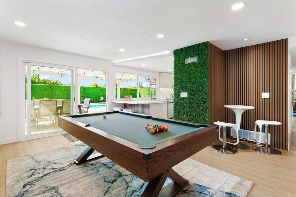 Elevate your leisure time in this vibrant space, featuring a classic billiards table set. 