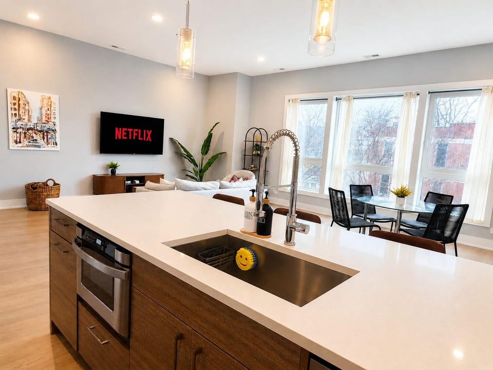 Bright open-concept kitchen, dining & lounge with large sunny windows
