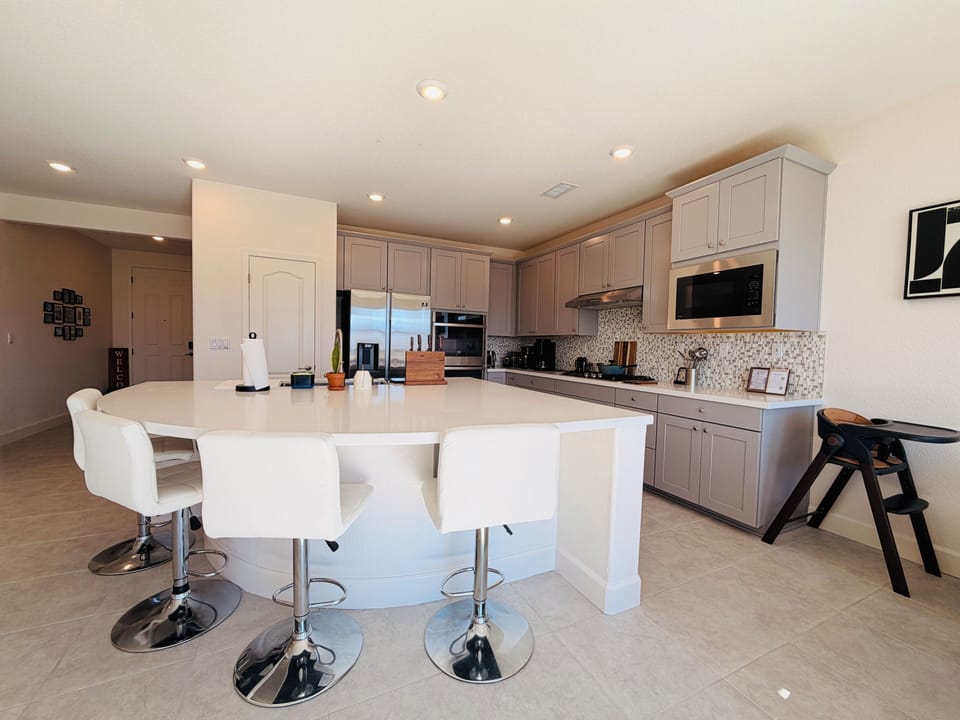 Fully stocked kitchen featuring a dedicated coffee and tea station with an espresso machine and a drip coffee machine. Complete with a gas stove, microwave, oven, ample cookware and dishes - everything you need to feel right at home.