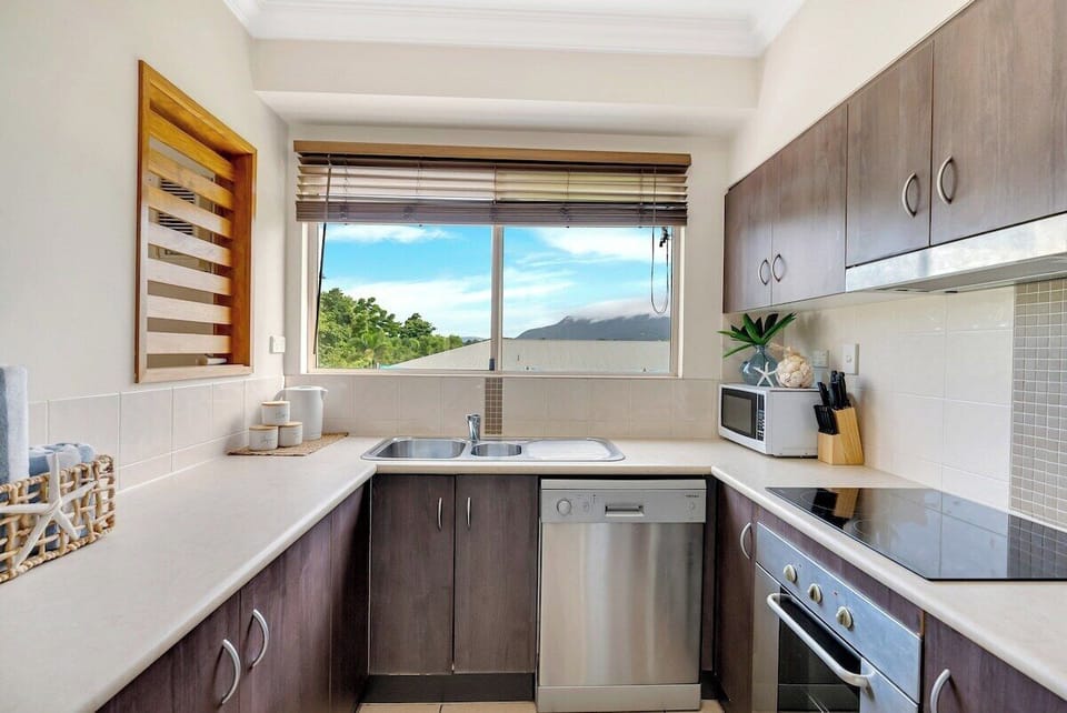 The fully equipped kitchen is designed with modern appliances, perfect for preparing delicious meals. 