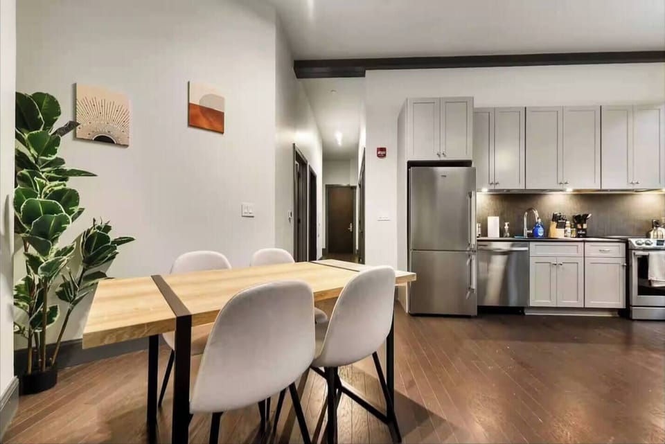 Modern open dining area with full kitchen and stylish finishes