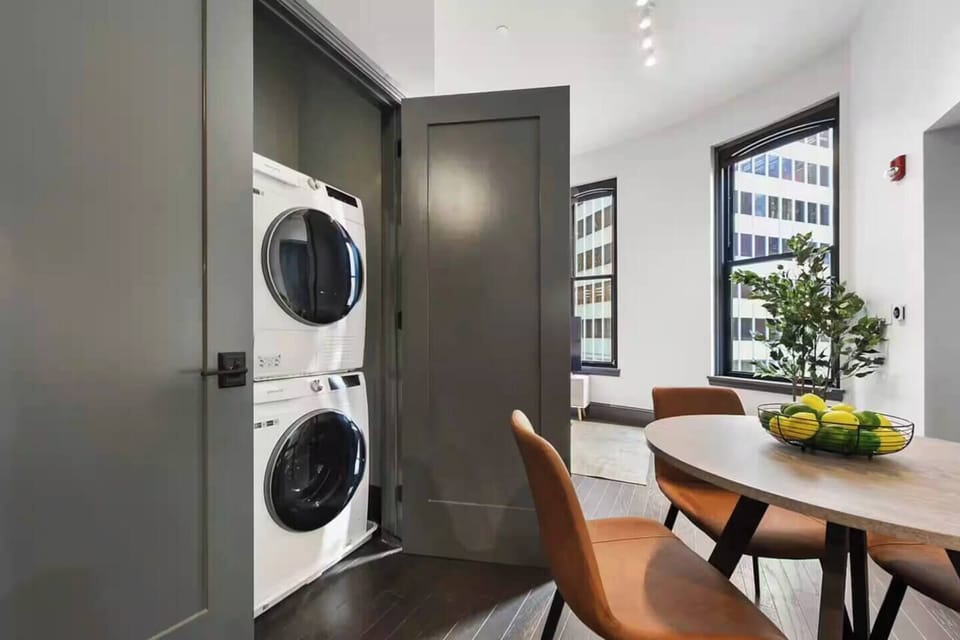 Bright dining nook with city views and convenient in-unit laundry