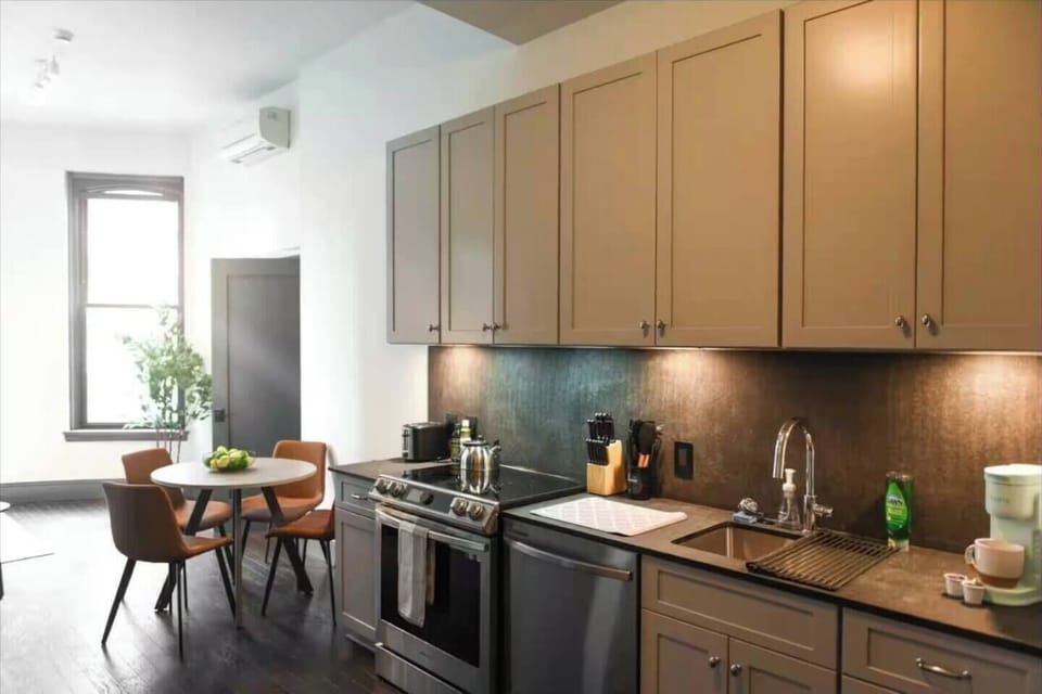 Modern kitchen with stainless appliances and a cozy window-side dining nook
