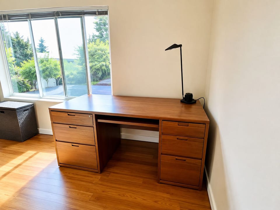 Bright window-side workspace with large desk and natural light