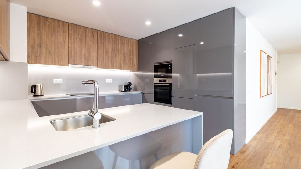 Whip up delicious meals in this sleek, fully-equipped kitchen, featuring modern appliances and ample counter space, making cooking a pleasure.