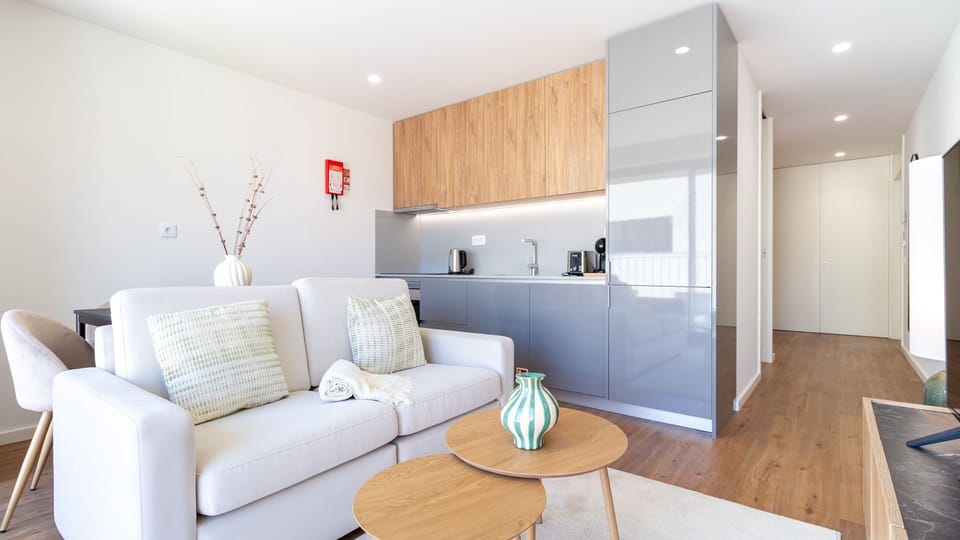 Experience seamless living in this open-concept space, where the stylish kitchenette flows effortlessly into the comfortable living area. The blend of sleek modern finishes and warm wood accents creates an inviting atmosphere for both cooking and relaxati