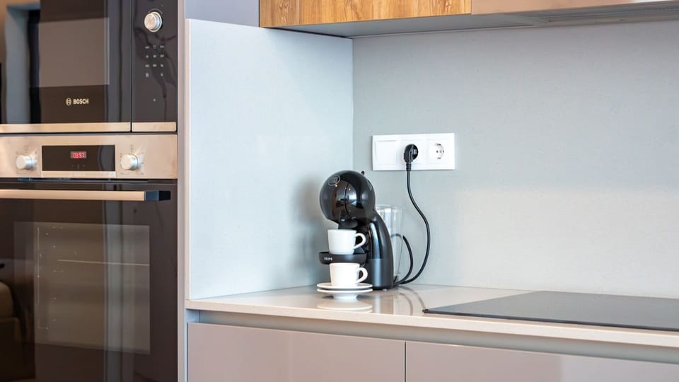 Start your day with a perfect cup of coffee from the espresso machine, and effortlessly prepare meals using the integrated oven and hob in this well-appointed kitchen. Everything you need for delicious dining is at your fingertips for a truly convenient s