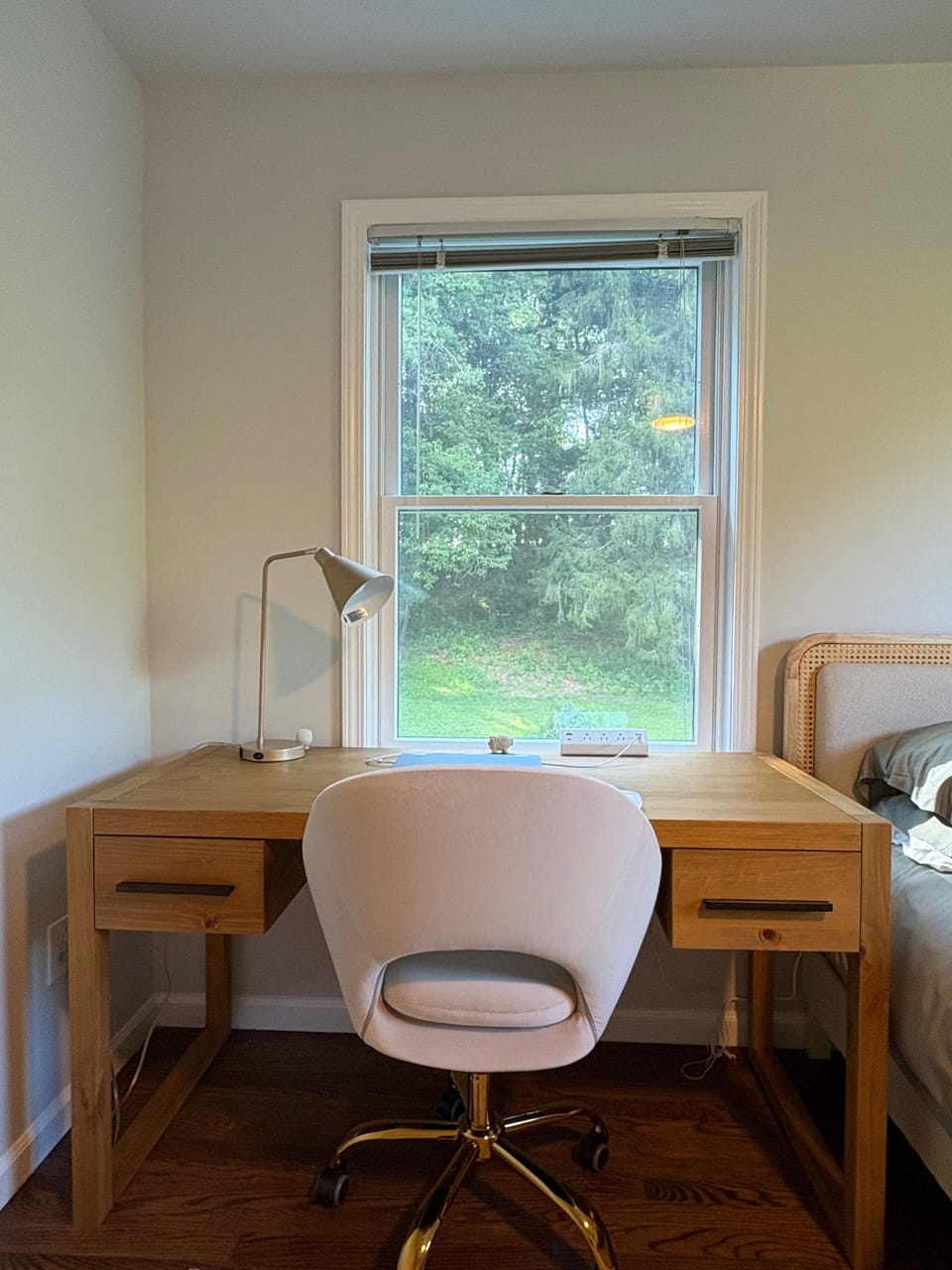 Perfect remote work set up with desk, lamp, outlets, desk chair and view of yard