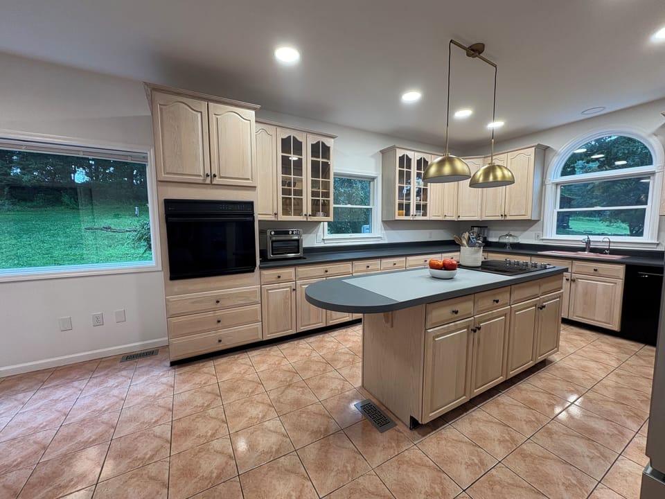 Chef's kitchen with island, wall oven, cooktop, air fryer, wood cabinets, views