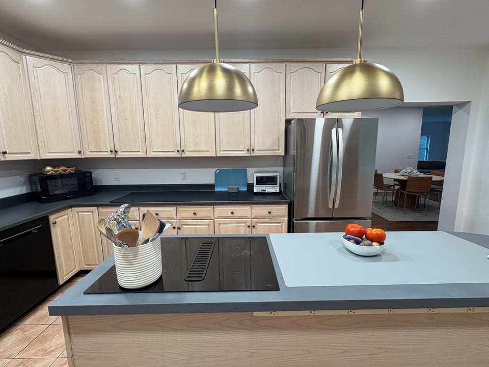 Kitchen with microwave, french door refrigerator, toaster oven, cooking utensils