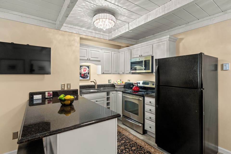 Stylish full kitchen with granite counters and charming designer details