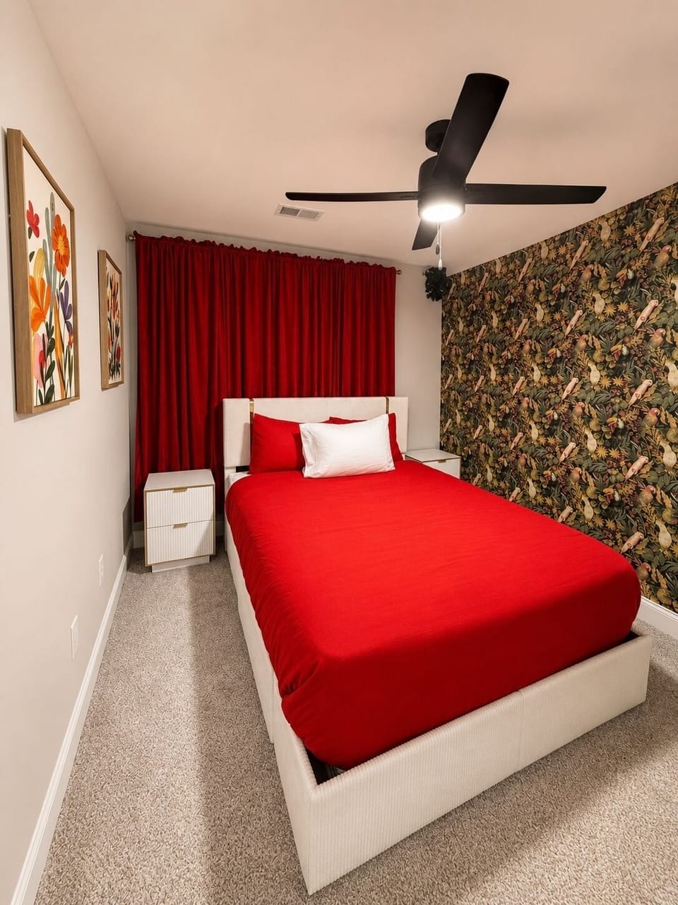 Bold red bedroom with botanical accent wall and blackout curtains