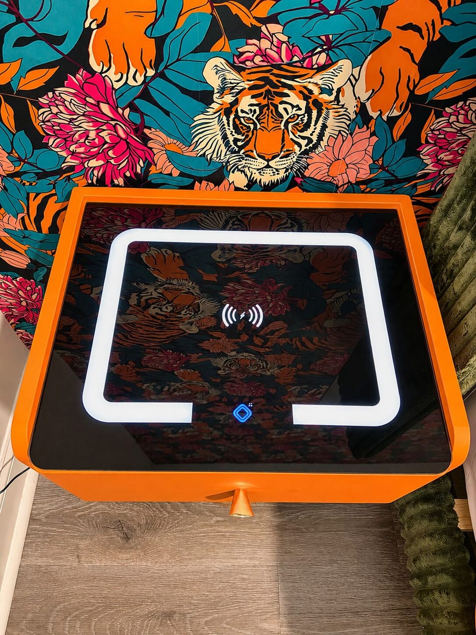 Bold jungle-chic side table with wireless charging and statement wallpaper