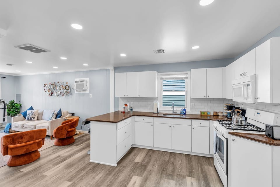 Bright open kitchen and cozy lounge with stylish coastal charm