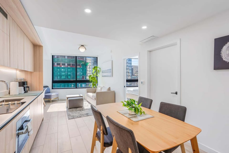 Bright and modern living space with city views, perfect for relaxation and dining.