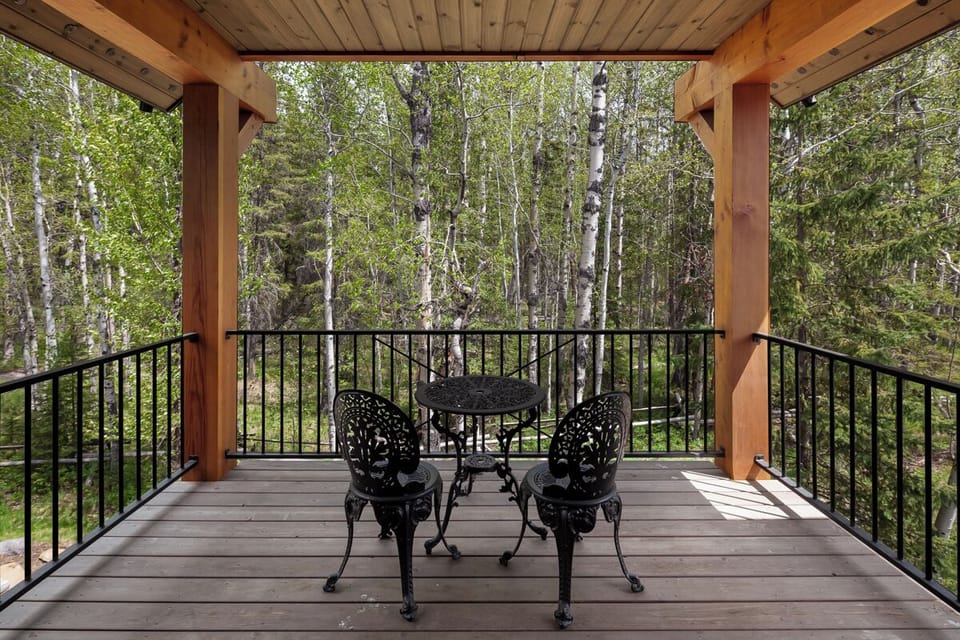 Sip morning coffee on the balcony surrounded by peaceful pines.