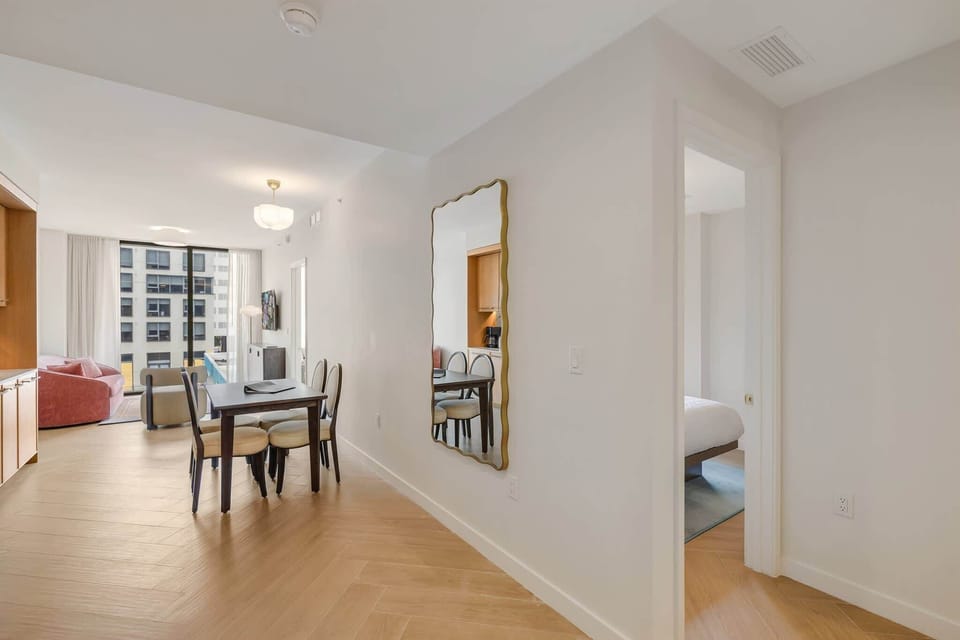 Bright and airy dining area with modern furnishings and a view into the cozy living space, perfect for gatherings.
