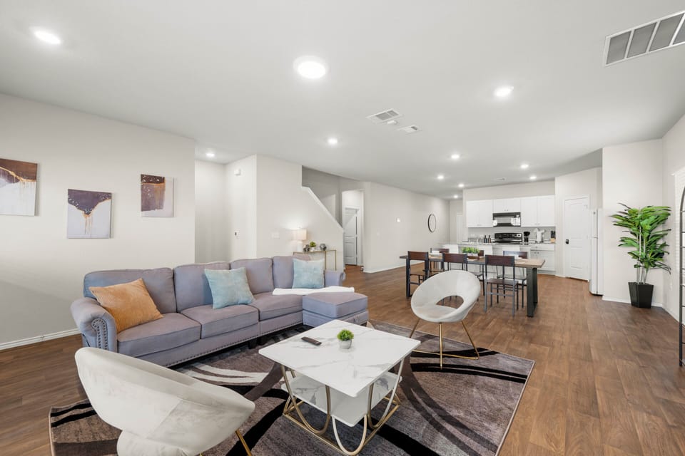 Bright open-plan lounge with chic kitchen, island, and dining space