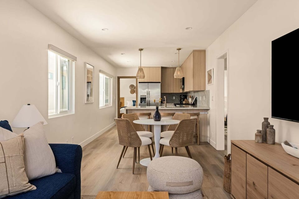 Open concept living room, dining area with breakfast bar and fully stocked kitchen.