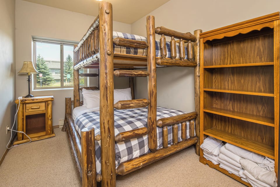 Rustic log bunk beds with plaid bedding | Main Level
