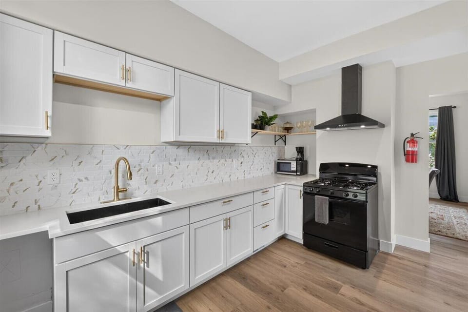 Fully equipped kitchen with an oven, stovetop, microwave, drip coffee maker, and cooking utensils. We also provide coffee, filters, oil, salt, and pepper.