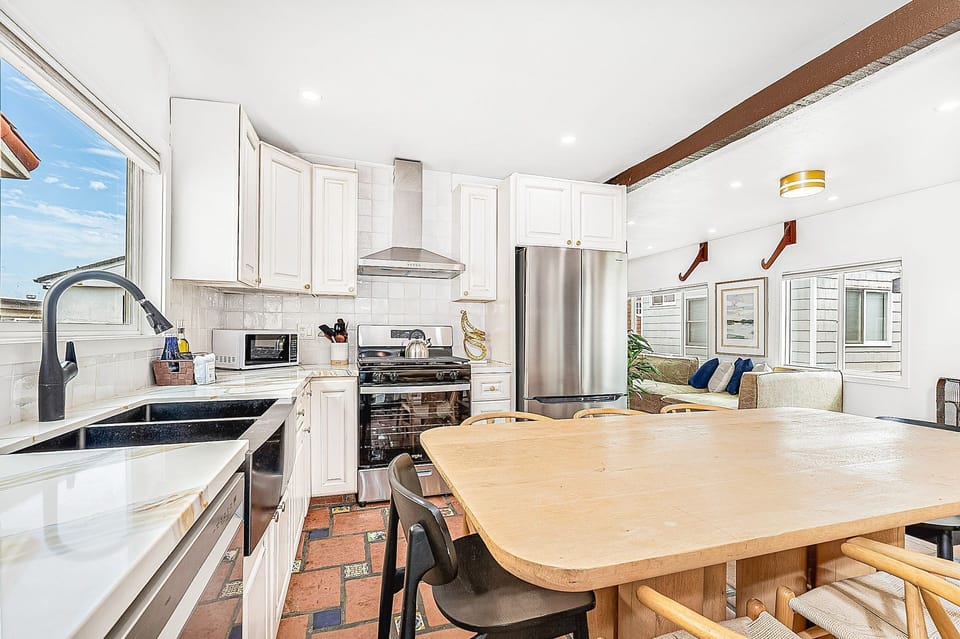 The open kitchen and dining area create an easy space for gathering together
                
