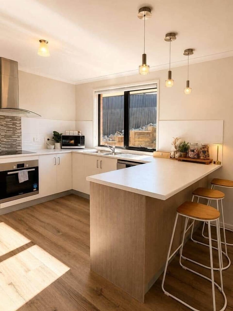 Bright Midway Point kitchen with generous bench space and breakfast seating.