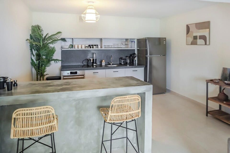 The kitchen area as seen from the living room. A great place to start your day with a coffee at the kitchen bar