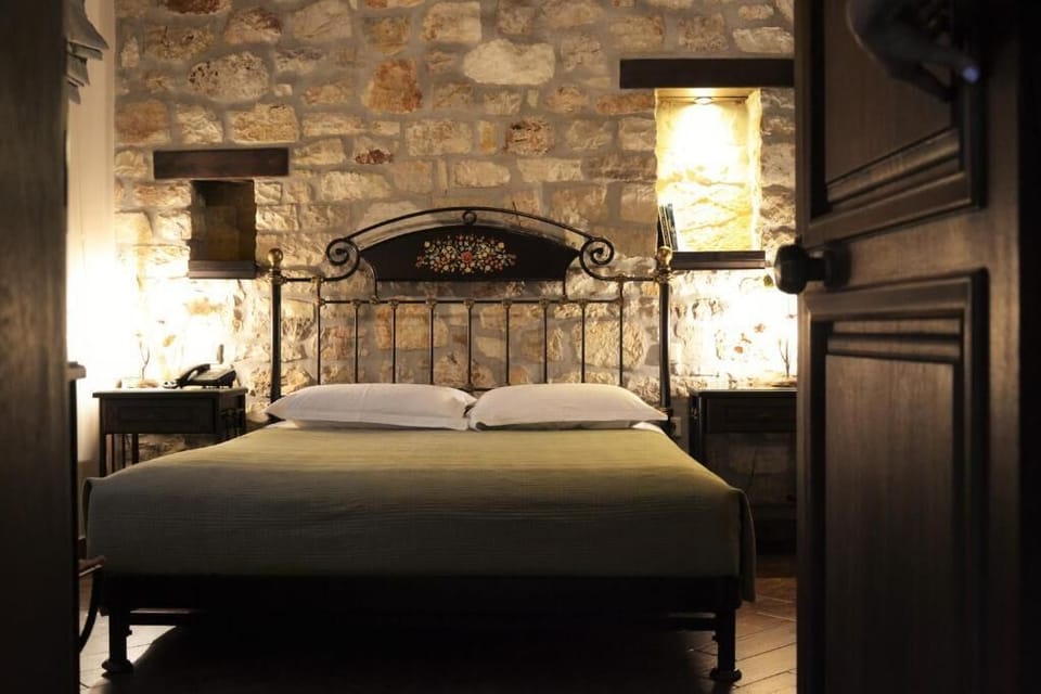 Triple Room – Comfortable Sleeping Area with Stone-Wall Character