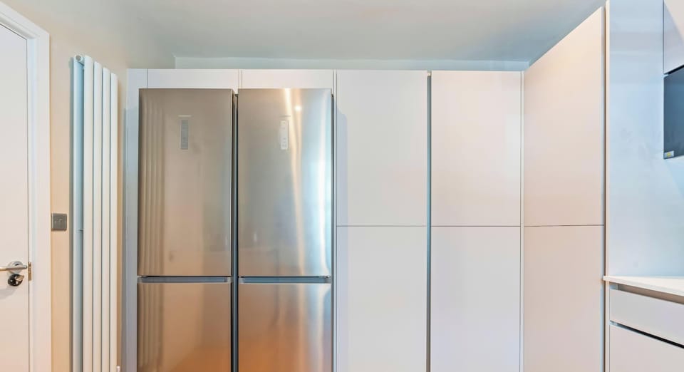 Modern kitchen with a full-size fridge-freezer for group stays.