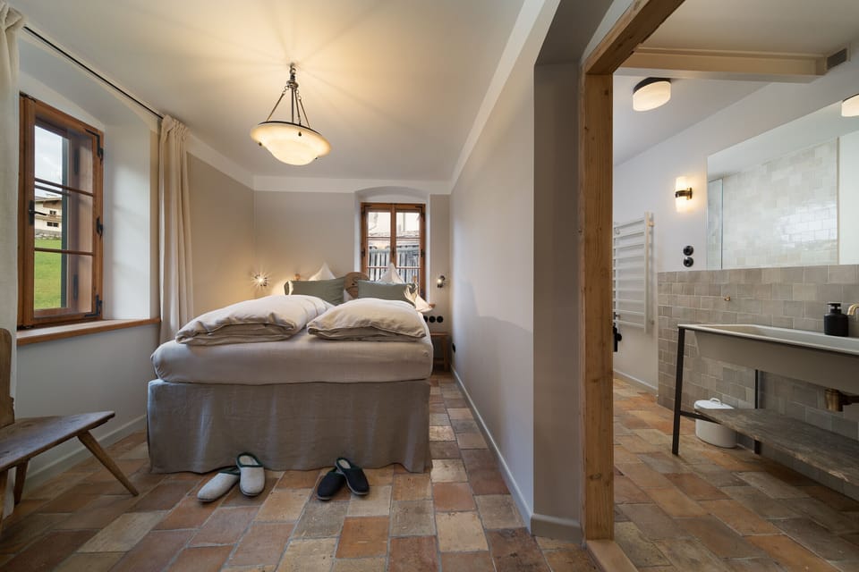 Book a chalet in Aschau near Kirchberg with stylish bedroom, private bathroom, high-quality finishes and modern Tyrolean interior.