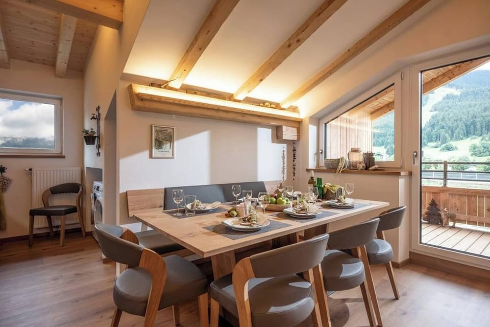 Book a luxury vacation apartment in the Brixental with large dining area, balcony access, mountain view and space for groups up to 8 guests.