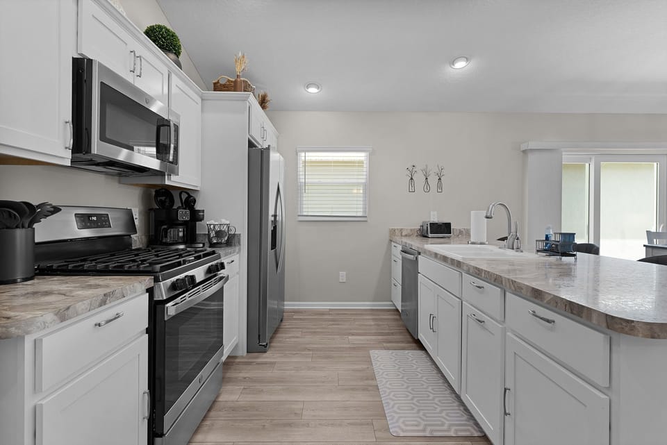 Step into your bright, modern kitchen with ample counter space for meal prep and stainless steel appliances that make cooking a breeze.