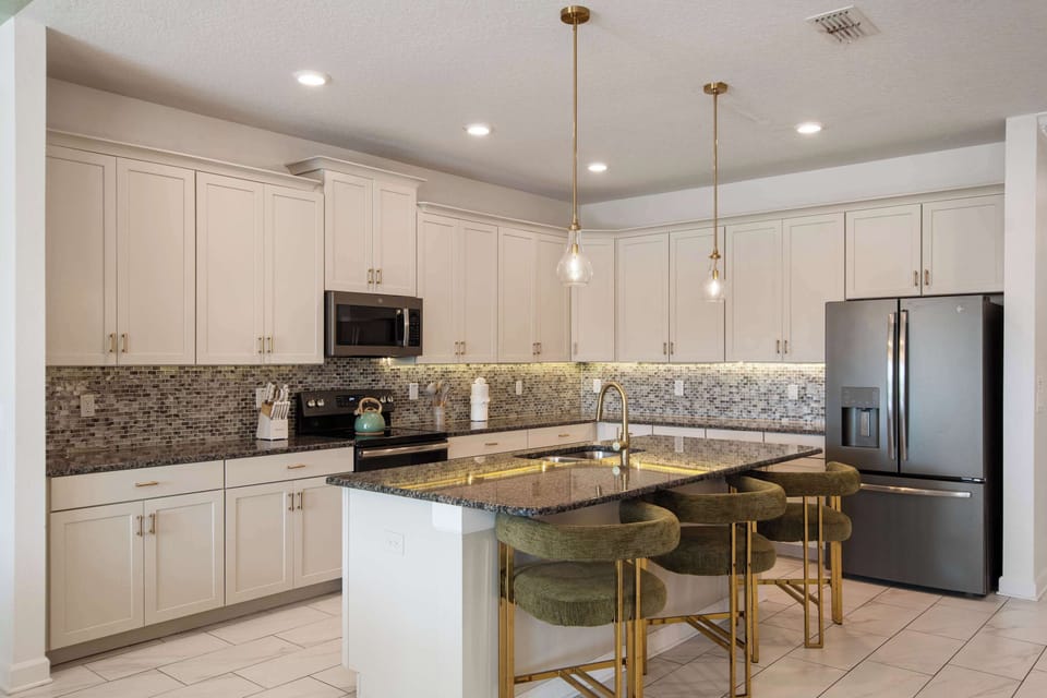The kitchen becomes a natural gathering place where meals are prepared, stories are shared, and everyone stays connected. Pull up a seat at the island, pour your favorite drink, and enjoy unhurried time with friends and family.