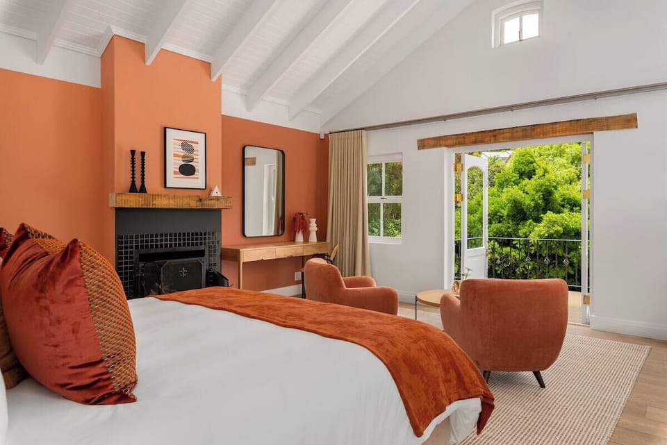 Bedroom 1 (Master) Upper level: King-size bed, En suite bathroom with bath, separate shower. Wood-burning fireplace. Sitting area. Desk and chair. Air-con. Opens up to a small terrace with garden and mountain views.