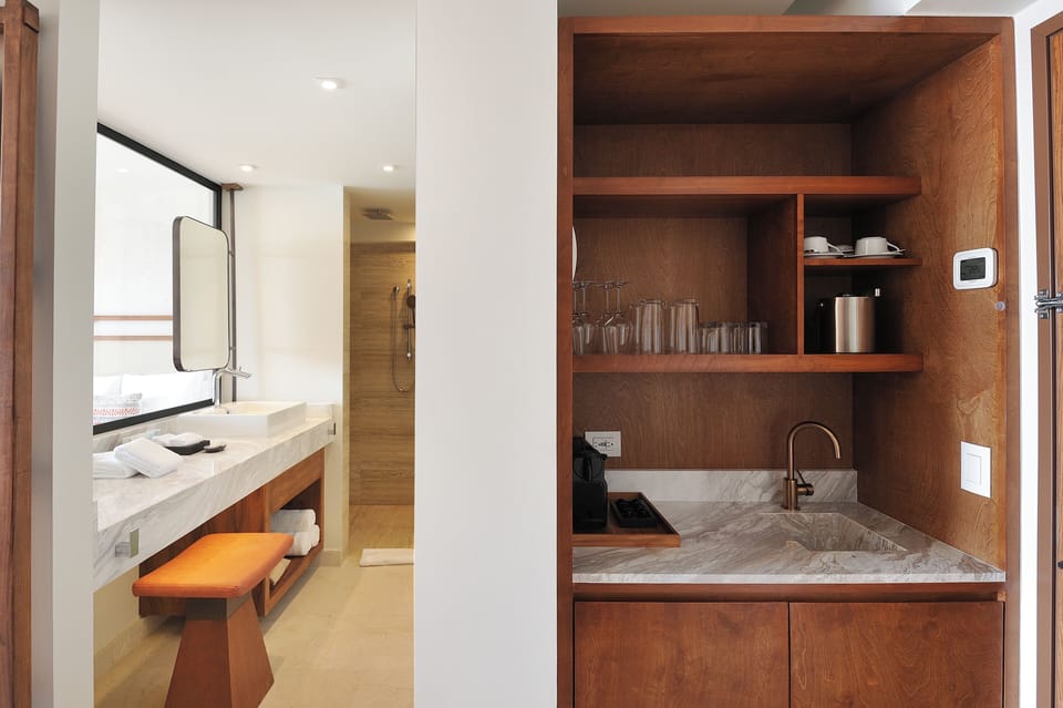 Enjoy easy mornings with a sleek minibar and sink