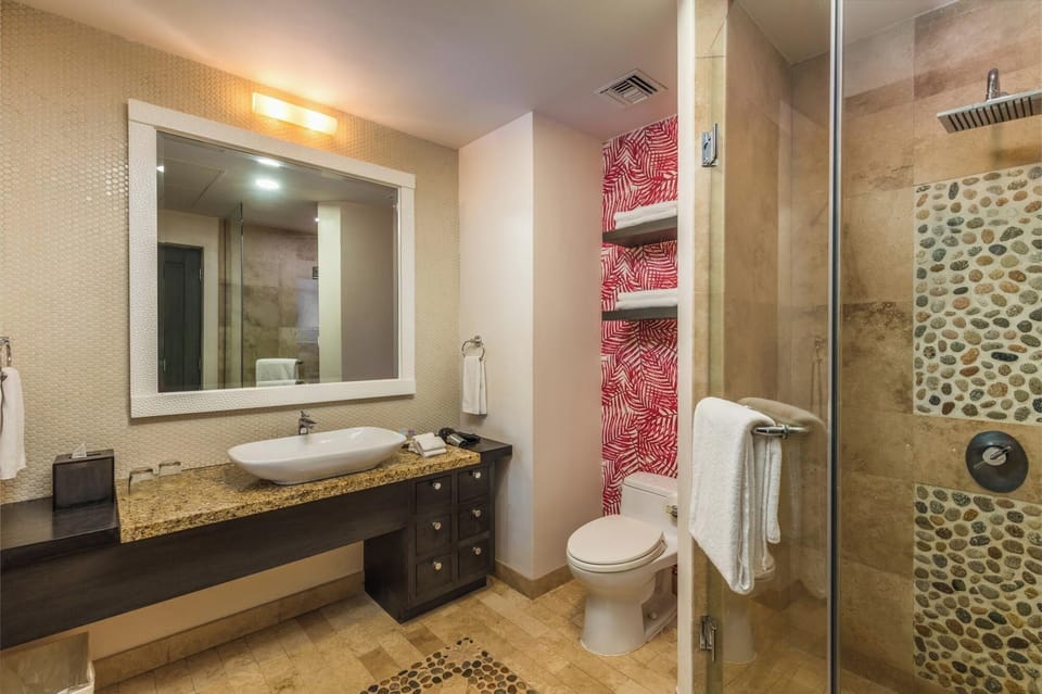 Refresh in a spacious bath with rainfall shower and vanity.