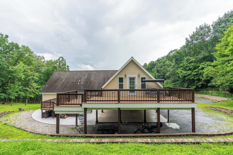 Private wooded retreat with a spacious wraparound deck and peaceful views