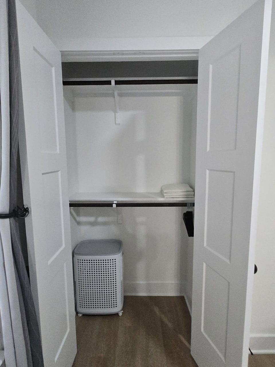 Spacious guest closet with shelves, hanging space, and linen storage