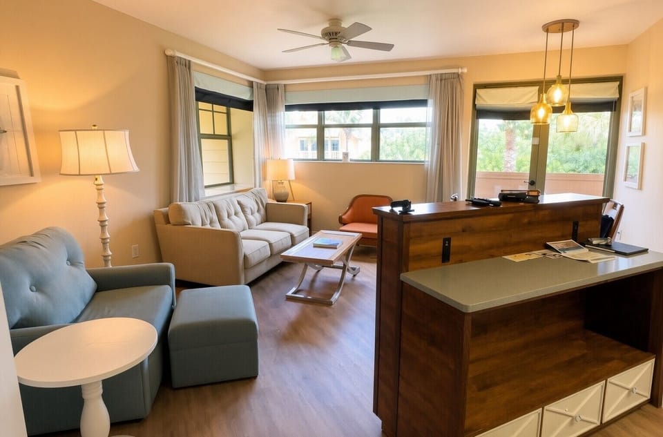 Living Area • Sofa, Kitchen Pass-Through & Windows