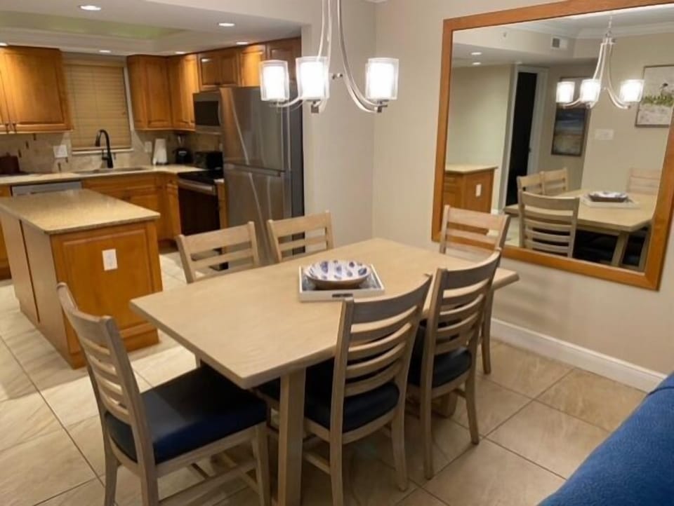 Bright dining for 6 with full kitchen, island, and modern lighting