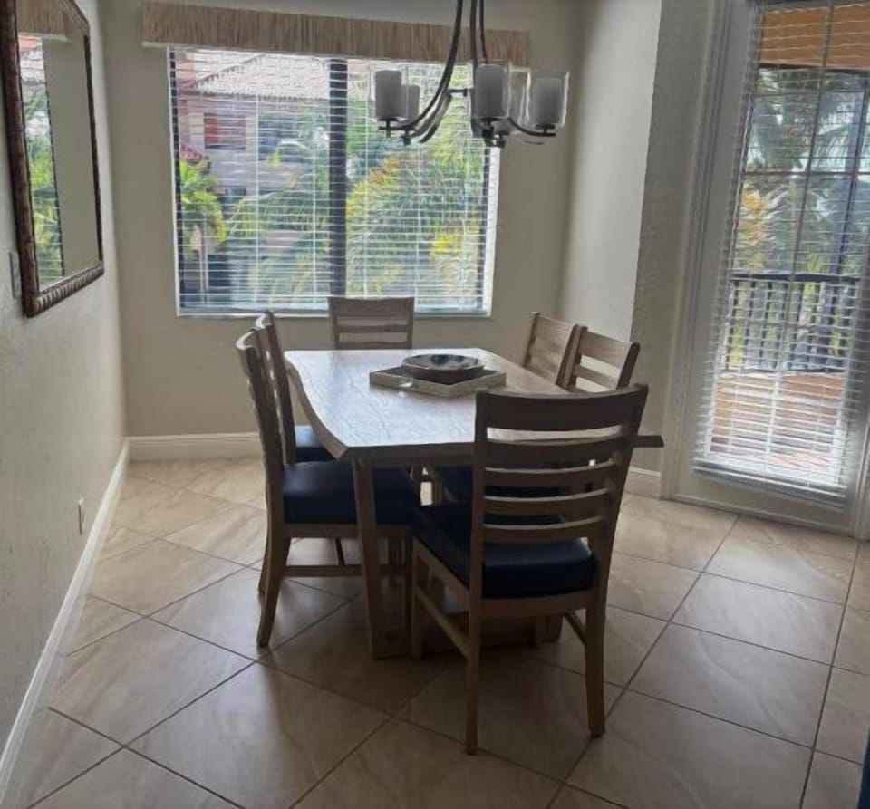 Bright dining nook for 4 with balcony access and sunny garden views