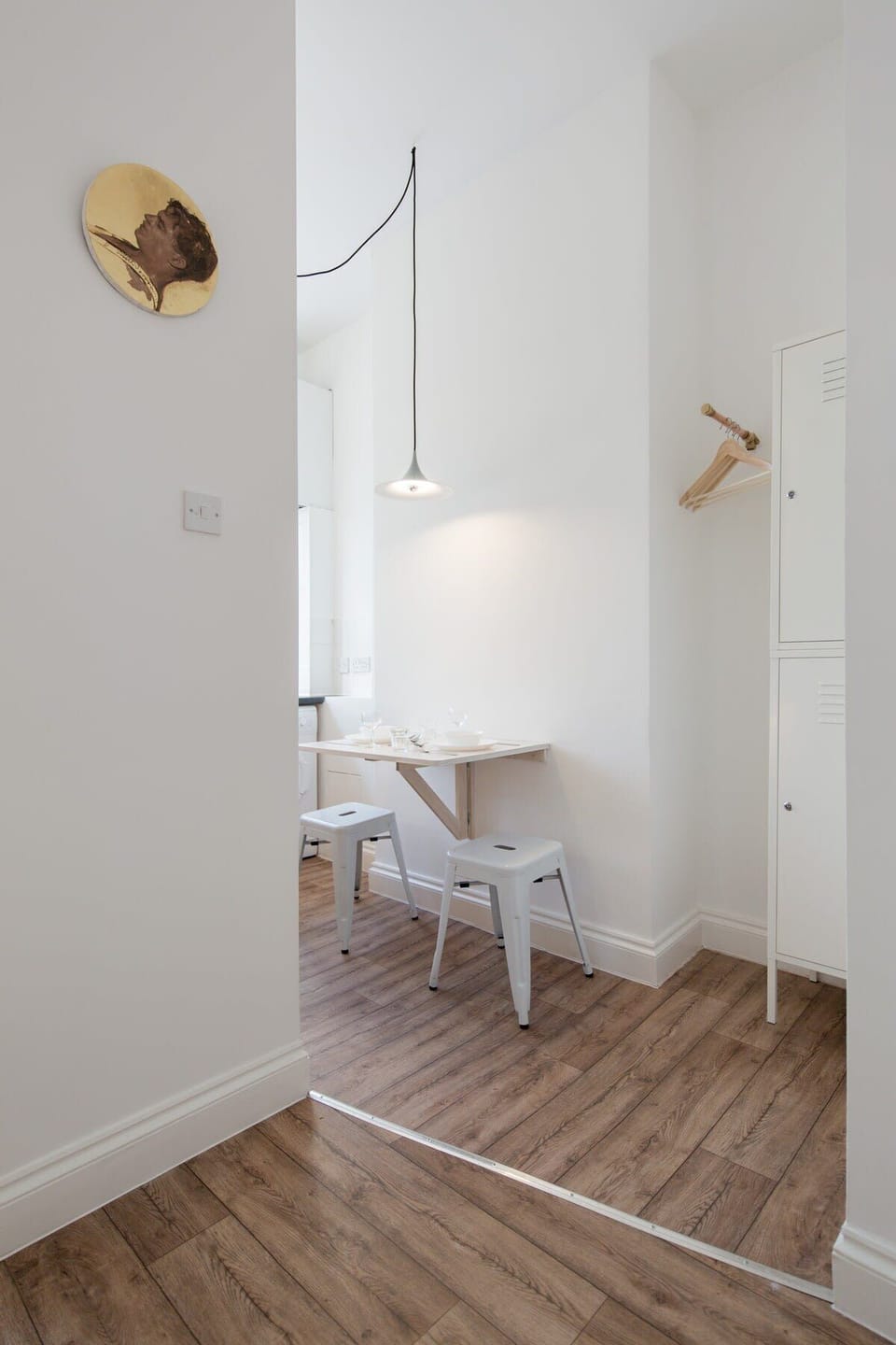 Pendant lamp by Claus Bonderup and Torsten Thorup, stools by Xavier Pauchard, original paintings by Alberto
