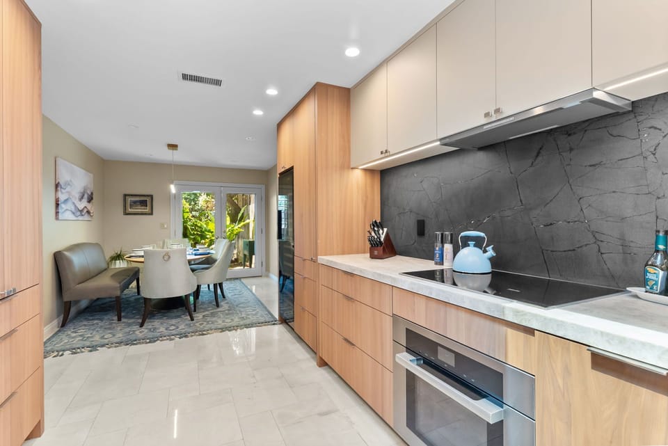 Modern designer kitchen with chic dining area and patio access