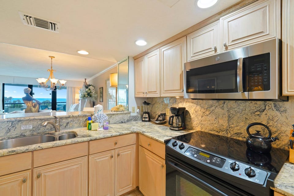 Enjoy the convenience of a spacious Gulf front vacation rental kitchen with granite countertops and everything needed for a relaxing beach getaway.