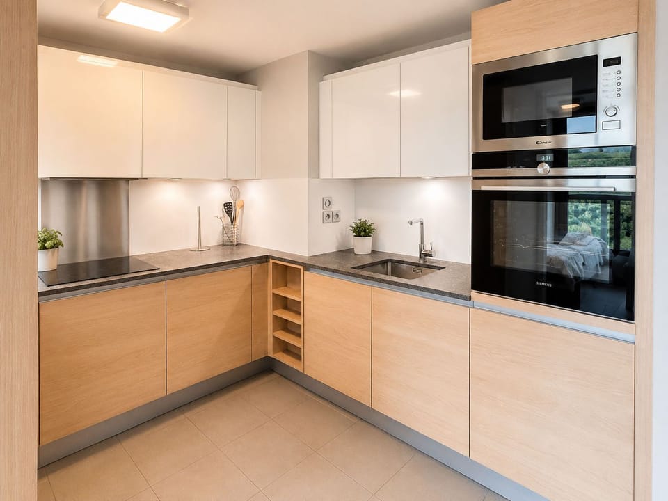 Sleek fitted kitchen with built-in oven, microwave, and induction hob