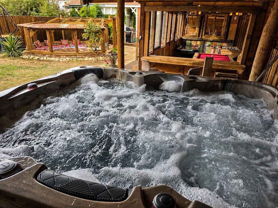 Hot tub available in front garden for relaxing stays.