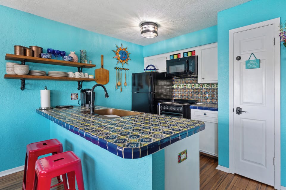 A fully equipped kitchen featuring modern appliances, ample counter space, and everything you need to prepare meals.