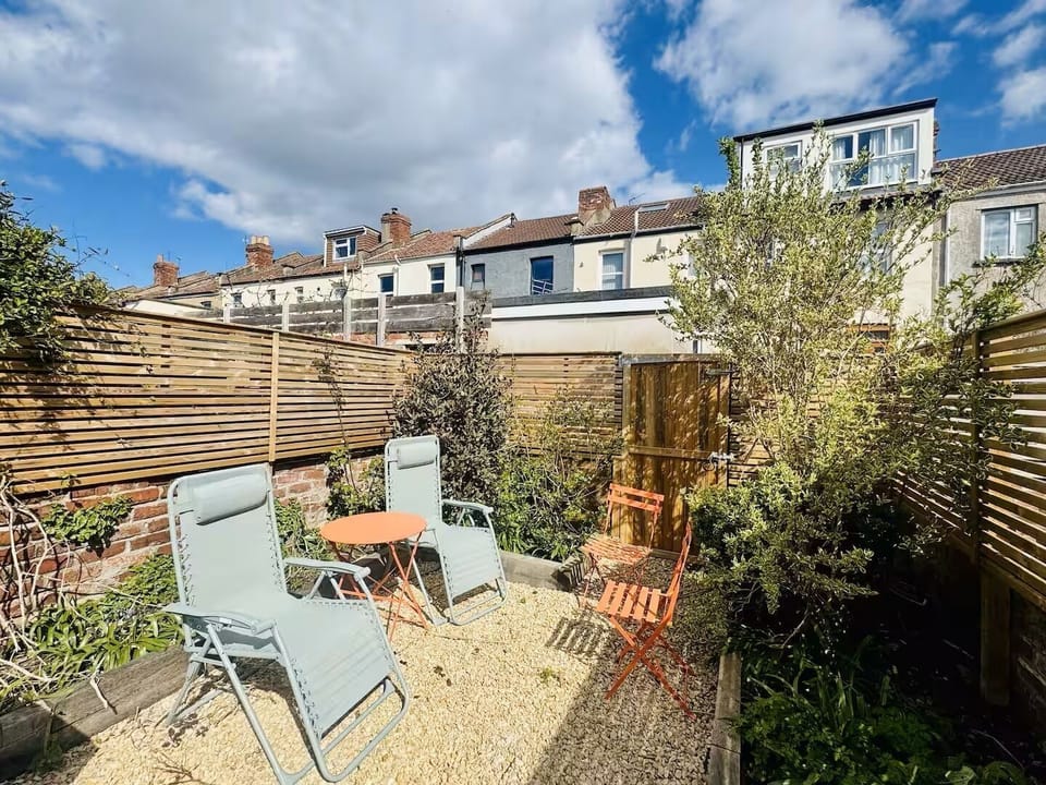The private garden features outdoor furniture and a dining table for al fresco meals