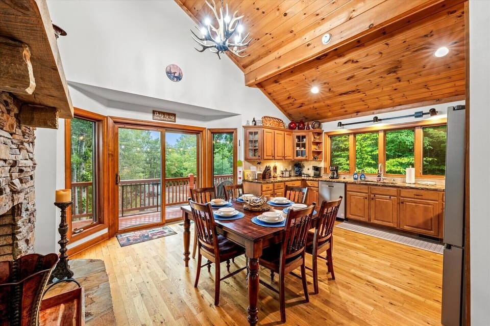 Cozy dining space with seating for six, set beside large windows that frame peaceful mountain views. Perfect for family meals or lingering over coffee together.
